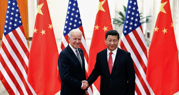 Chinese President Xi Jinping shakes hands with U.S. Vice President Joe Biden (L) inside the Great Hall of the People in Beijing December 4, 2013. REUTERS/Lintao Zhang/Pool//File Photo