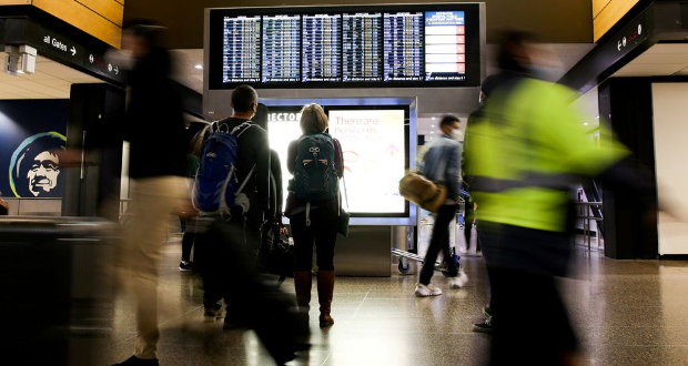 Travellers check a departures list at the ticketing level of Seattle-Tacoma International Airport before the Thanksgiving holiday in Seattle, Washington, U.S. November 24, 2021