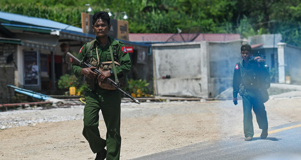 File photo: Myanmar soldiers walking along the Pyidaungsu highway road outside Kutkai in Shan State on August 25, 2019 AFP