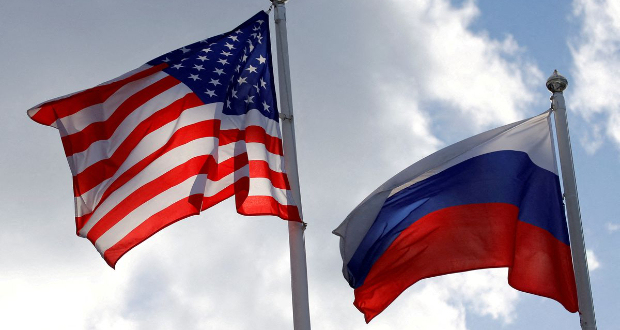 Russian and U.S. state flags fly near a factory in Vsevolozhsk, Leningrad Region, Russia March 27, 2019. REUTERS/Anton Vaganov/File Photo