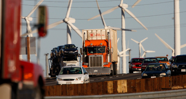 Motorists pass by wind turbines near Banning, Calif. Rising carbon emissions threaten to derail President Biden's climate goals. David McNew/Getty Images