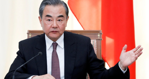 China's FM said his country opposes "external interference" in how other countries are run. [Pavel Golovkin/Pool via Reuters