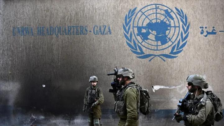 Israeli soldiers operate next to the UNRWA headquarters in the Gaza Strip, in February 2024 [File: Dylan Martinez/Reuters]